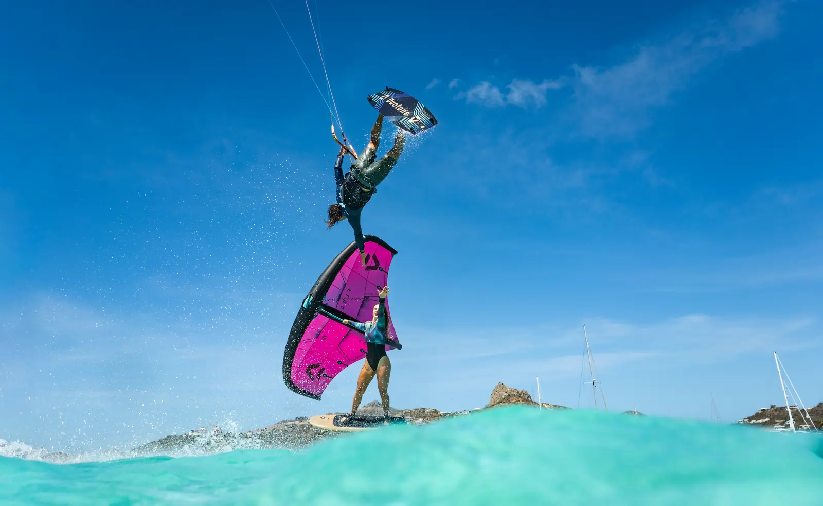 Kitesurfer riding over clear water in the Grenadines