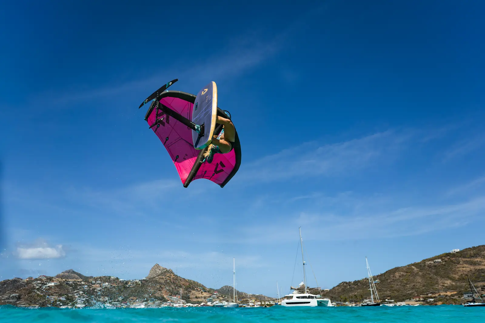 Wing foiler riding above turquoise Union Island water